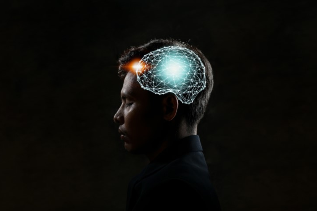 頭部に光るネットワーク状のグラフィックを重ねた人物の横向きシルエット