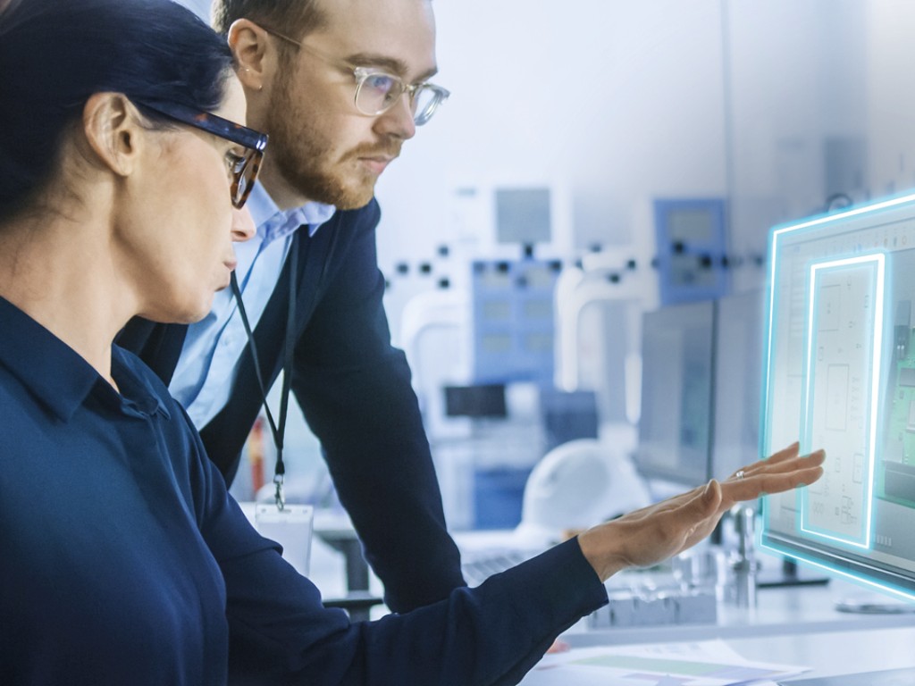 Two employees looking at a monitor