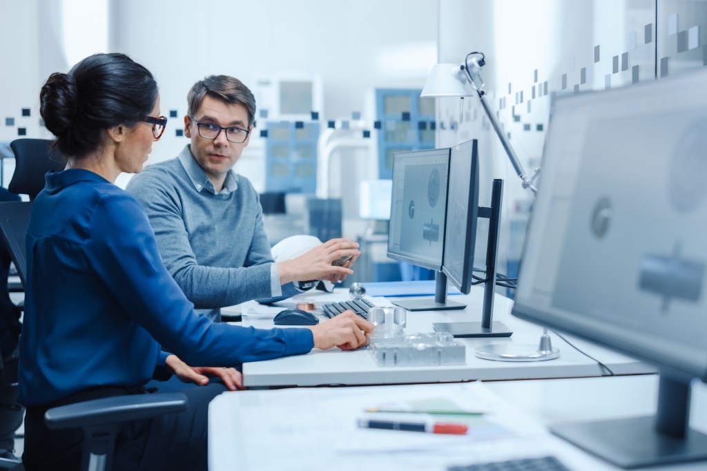 A man and a woman on a PC preparing a Declaration of Conformity.